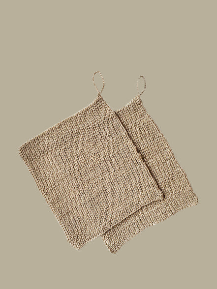 Two beige textured hemp washclothes 
on a white background