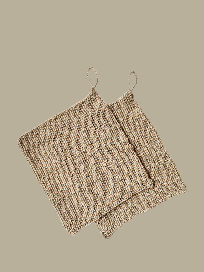 Two beige textured hemp washclothes 
on a white background