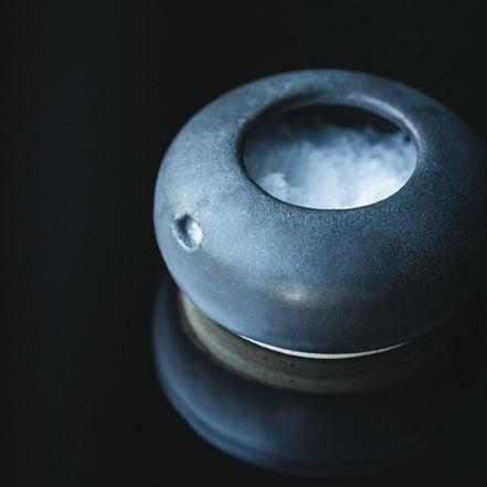 Ceramic salt cellar on a black background
