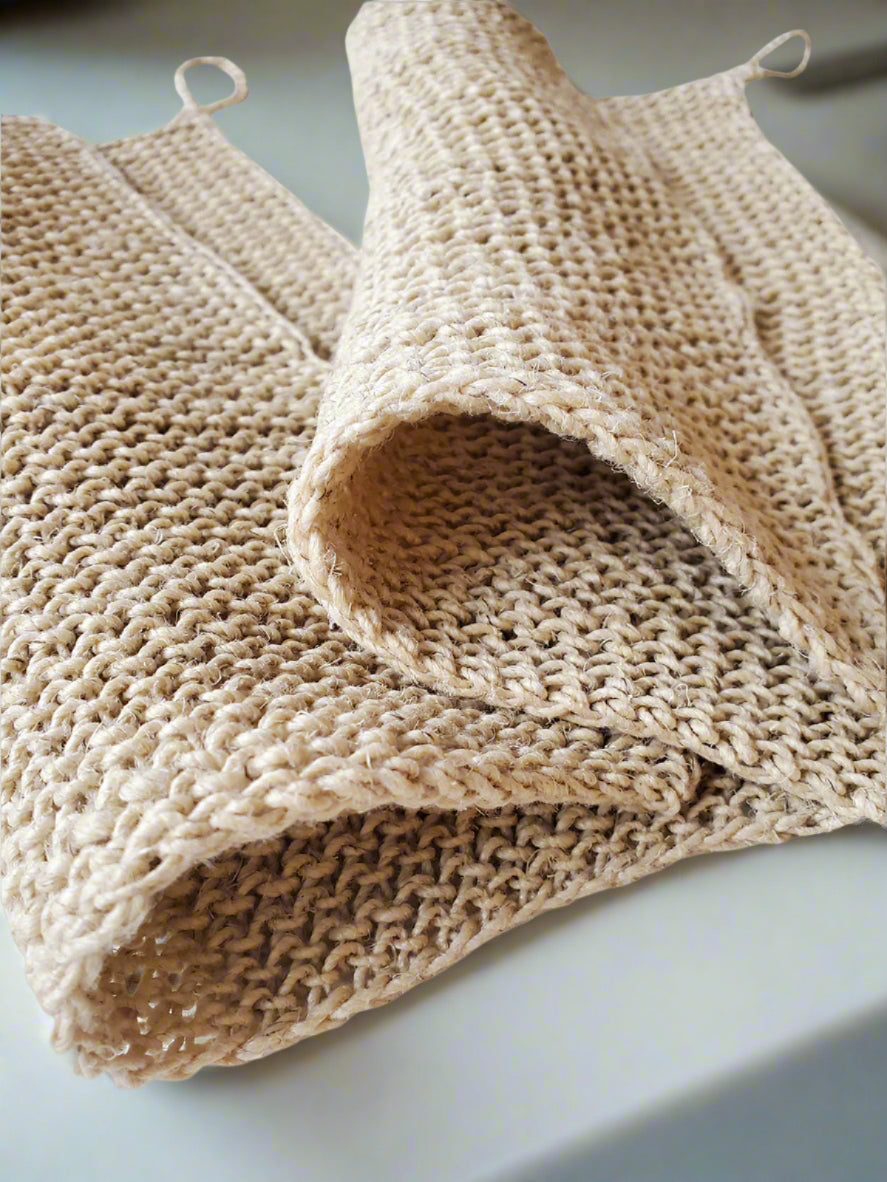 Close-up of a beige hemp washcloth on a white background