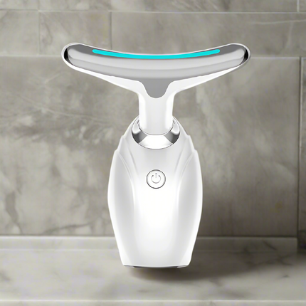 White facial cleansing device with a blue light on a white background