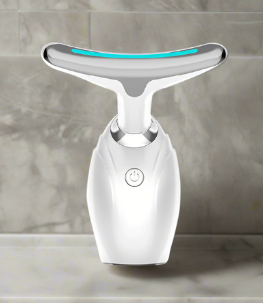 White facial cleansing device with a blue light on a white background