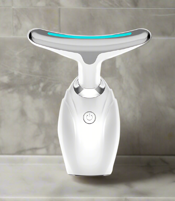 White facial cleansing device with a blue light on a white background