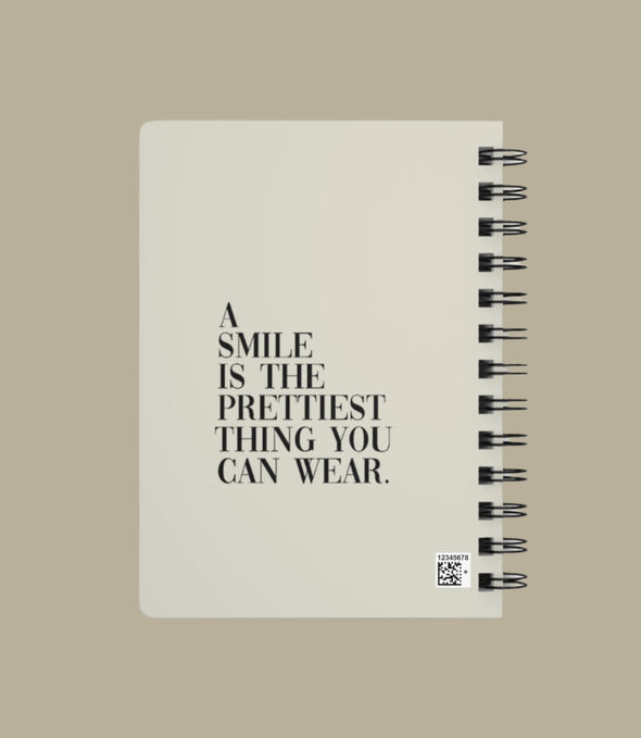 Notebook with motivational quote on a white background