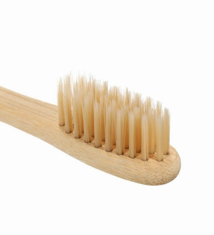 Wooden toothbrush with bristles on a white background